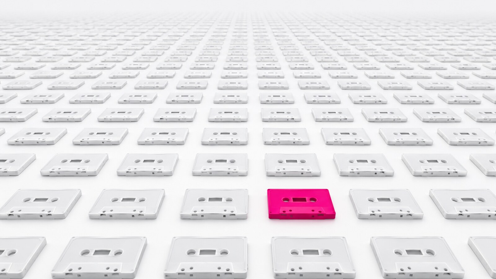 A grid of hundreds of identical blank white cassette tapes receding to the horizon, with exactly one picked out in hot pink